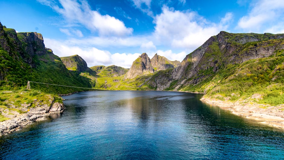 Beautiful landscape of a fjord surrounded by mountains and clear water in Moskenes, Norway.